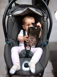 Full length of cute baby girl sitting in kitchen