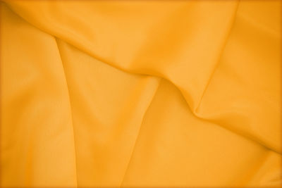 Full frame shot of yellow silk on table