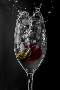 Close-up of beer glass against black background