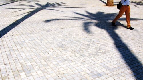 Low section of people standing on tiled floor