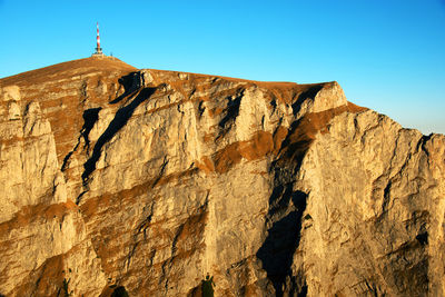 Low angle view of rocks against clear sky