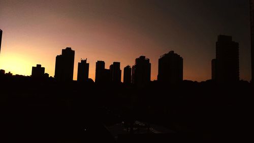 Silhouette of city at sunset