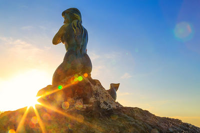 Low angle view of statue against sky during sunset