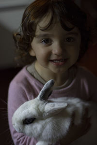 Portrait of cute girl with a white rabbit