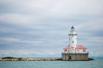 Lighthouse against cloudy sky