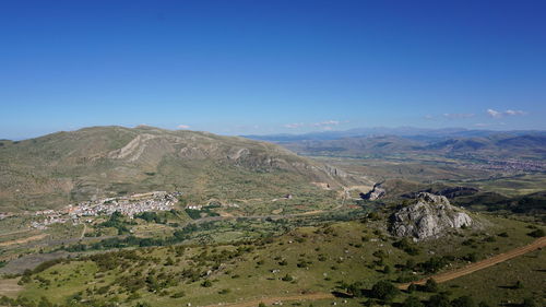 Scenic view of mountains against clear blue sky