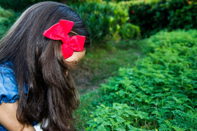 Close-up of girl with red bow