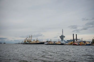 Commercial dock by sea against sky