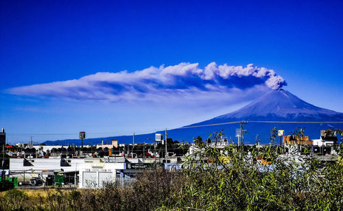 Scenic view of mountains against blue sky