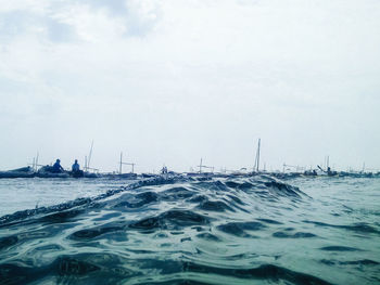 Sailboats sailing on sea against sky