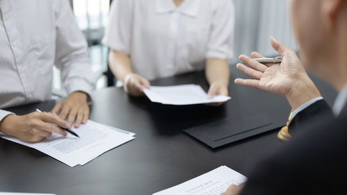 Midsection of business colleagues working in office