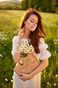 Portrait of young woman holding flower