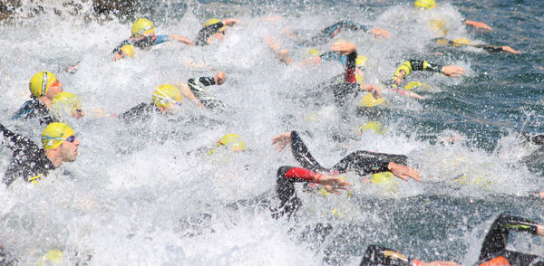 High angle view of people swimming in sea