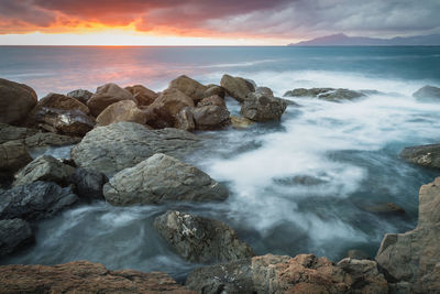 Scenic view of sea against sky during sunset