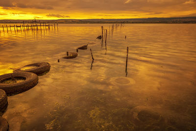 Scenic view of lake against sky during sunset