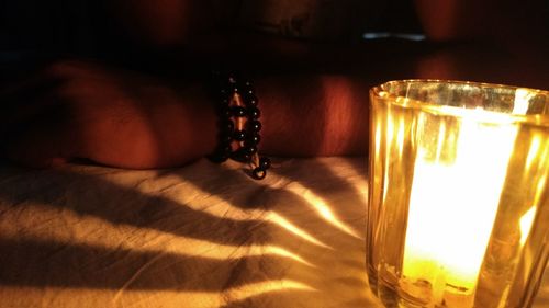 Close-up of illuminated lamp on table