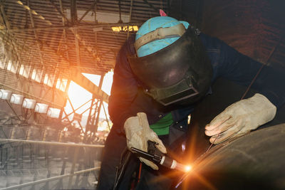 Man working on metal grate