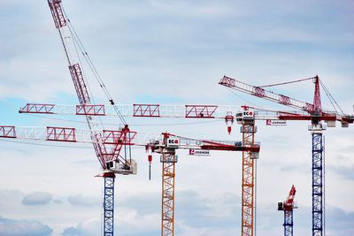 Low angle view of crane against sky