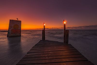 Lifeguard hut at beach during sunset