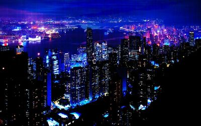 Illuminated cityscape against sky at night