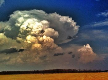 Scenic view of landscape against cloudy sky