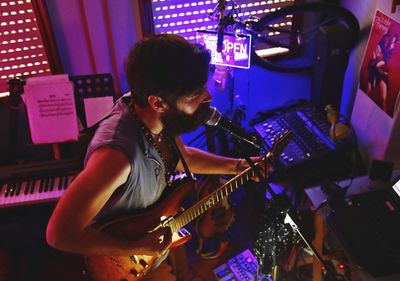 Man playing guitar at music concert