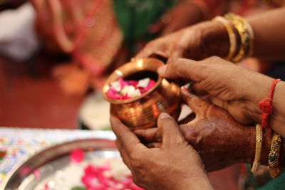 Midsection of woman holding cross