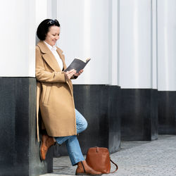 Side view of woman using mobile phone