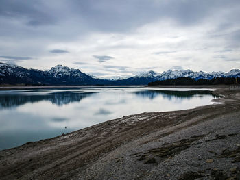 Scenic view of lake against sky during winter