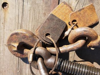 Close-up of rusty chain on wooden door