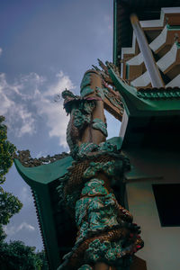 Low angle view of statue against cloudy sky