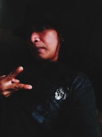 Midsection of person with hand on black background