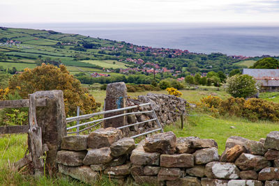 Built structure on landscape against sky