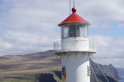 Lighthouse against cloudy sky