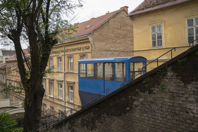 Building by canal against sky