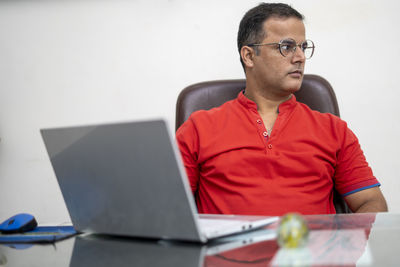 Mid adult man using laptop on table