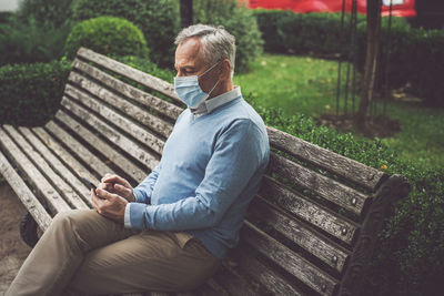 Man sitting on bench in park