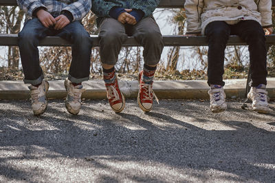 Low section of people sitting on road