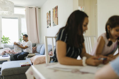 Women sitting on table at home