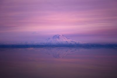 Scenic view of snowcapped mountains against sky during sunset