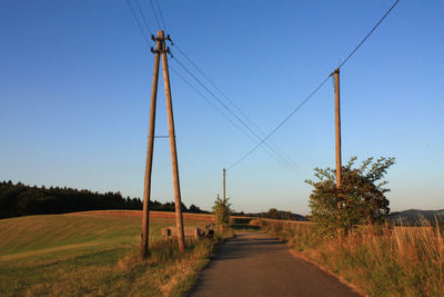 Narrow road along countryside landscape