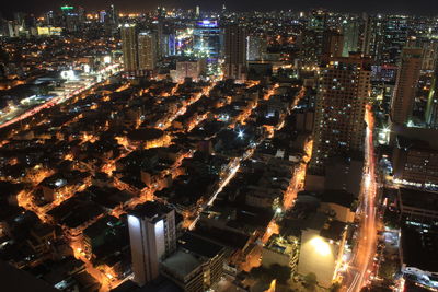 High angle view of city lit up at night