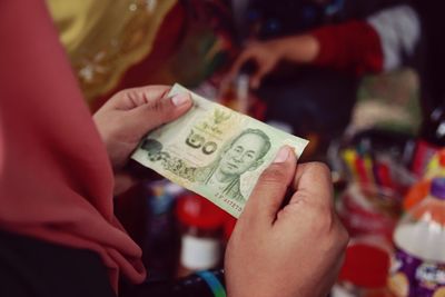 Close-up of hand holding paper currency