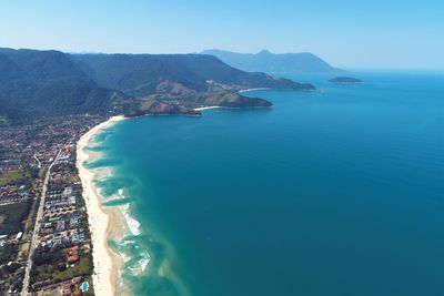 High angle view of sea and mountains against sky