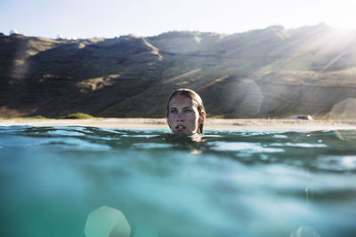 Portrait of young man swimming in pool