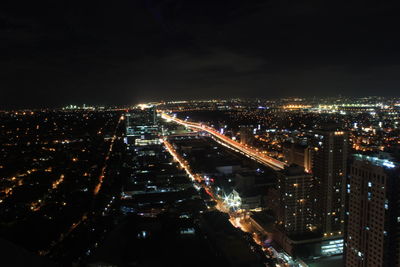 High angle view of illuminated buildings in city at night