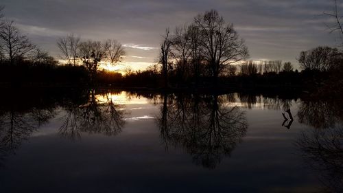 Scenic view of lake against sky at sunset