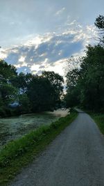 Road amidst trees against sky