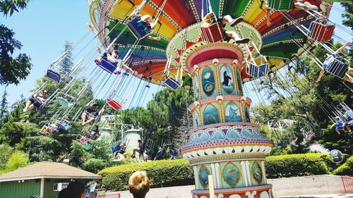 Low angle view of ferris wheel against building