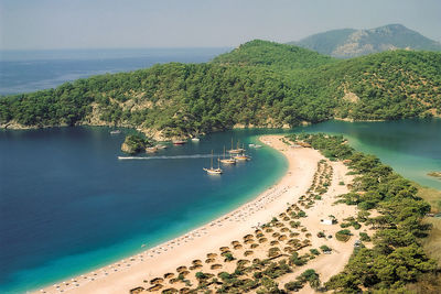 High angle view of sea and mountains against sky